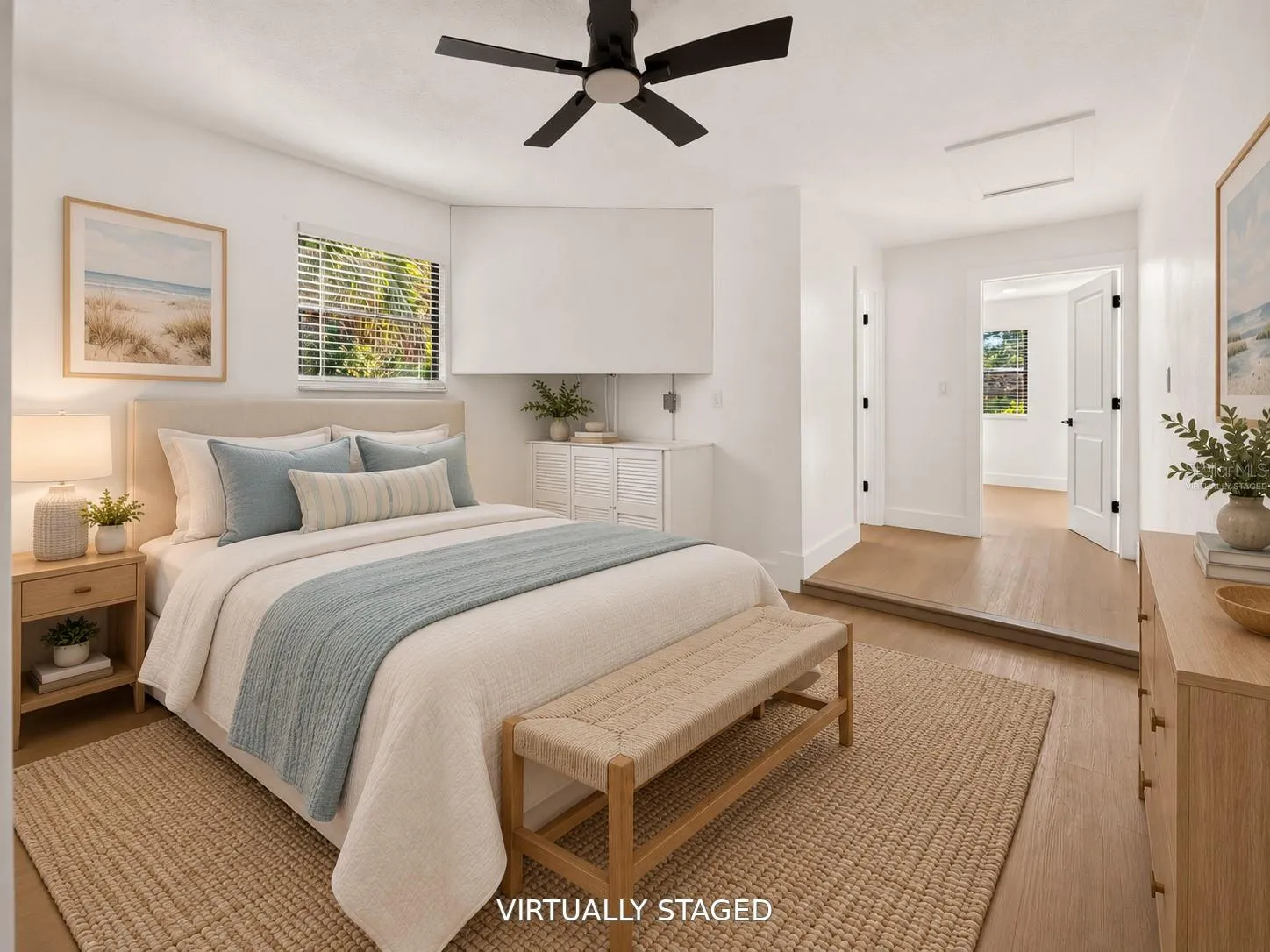 VIRTUALLY STAGED. Bright secondary bedroom featuring updated flooring and a modern black ceiling fan.