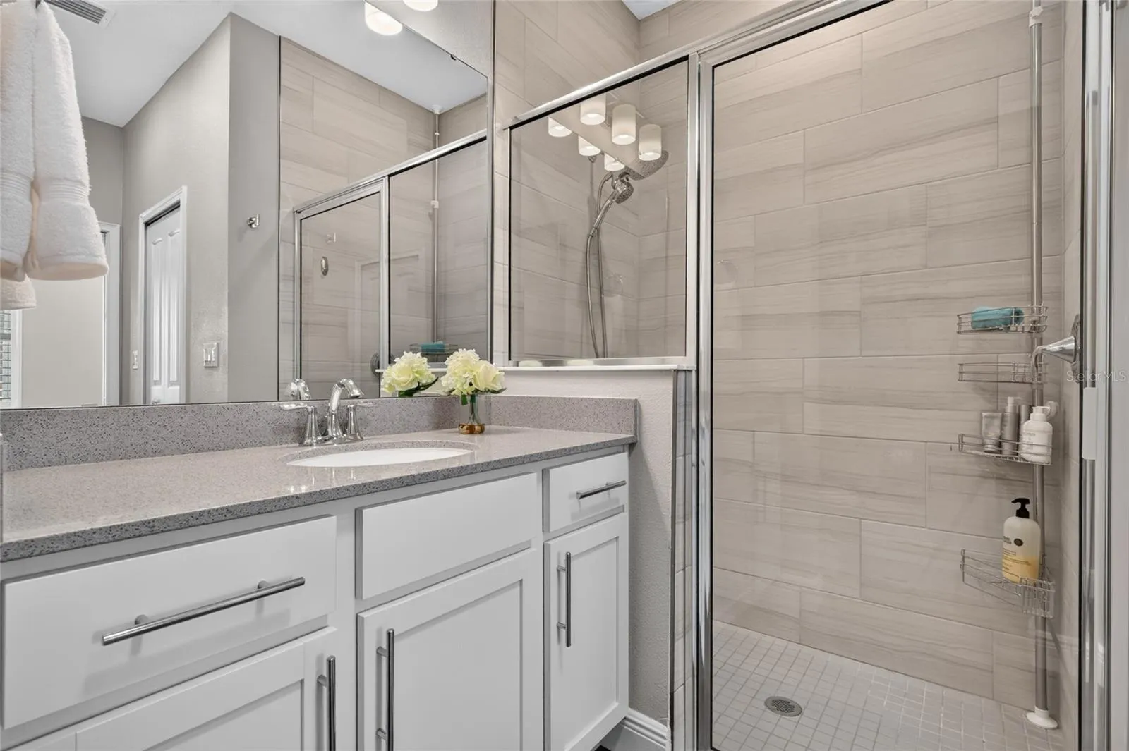 walk in shower with floor to ceiling ceramice tile