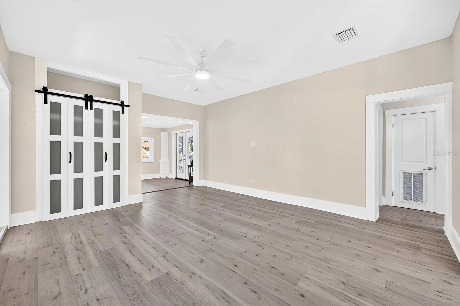 The spacious Living Room flows into the Dining Area and Kitchen.