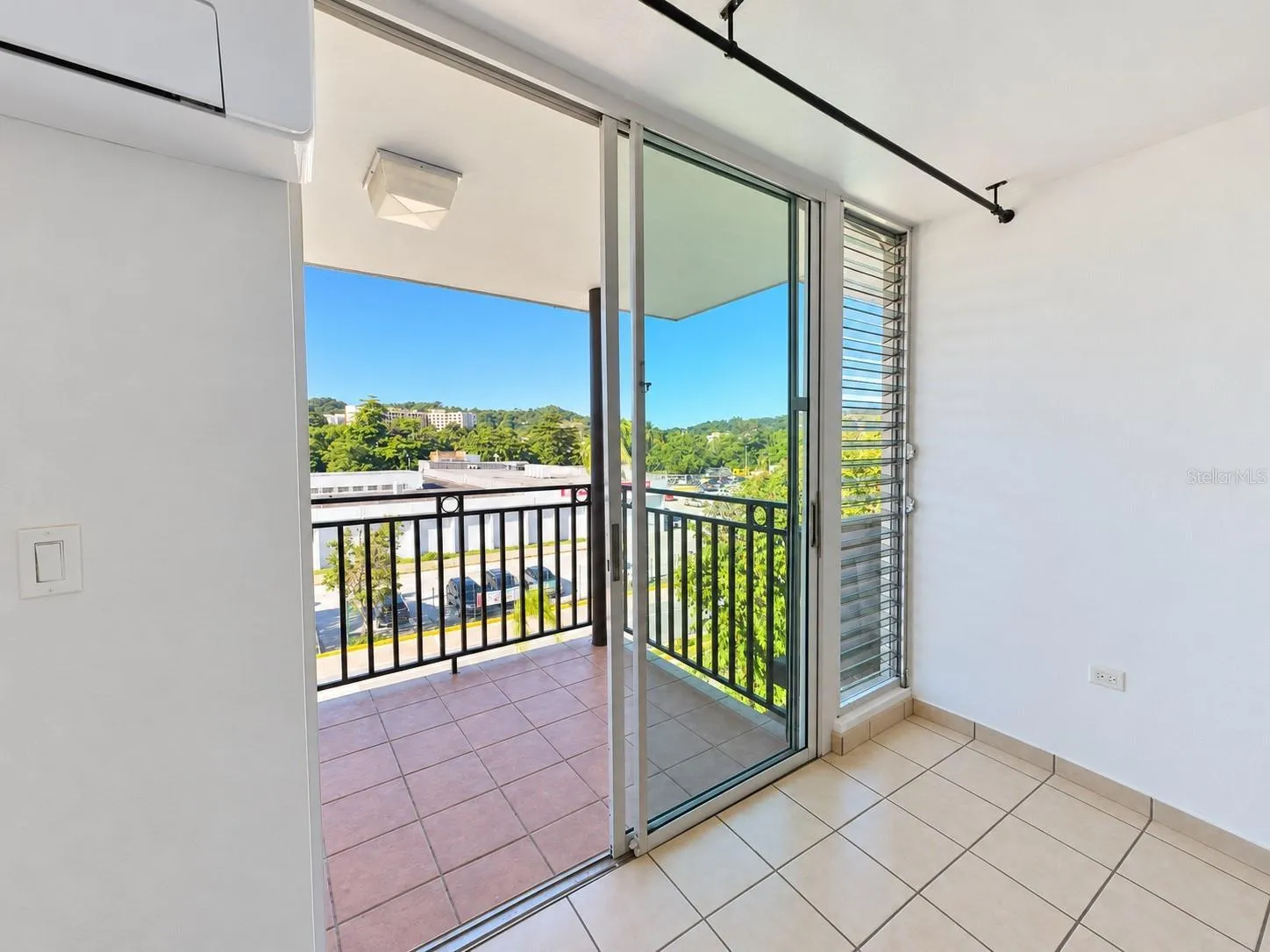 Covered main-level balcony accessed through sliding glass doors.