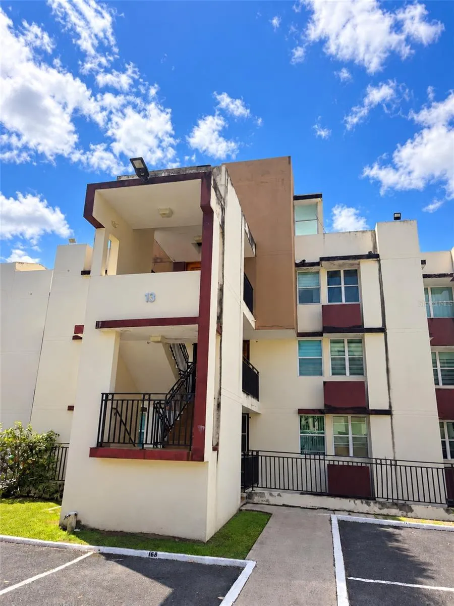 Front exterior of Building 13, featuring the stairway access to penthouse Unit 1307.