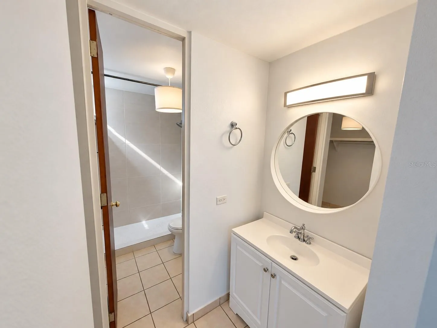 Primary bathroom with a separate vanity area and walk-in shower.