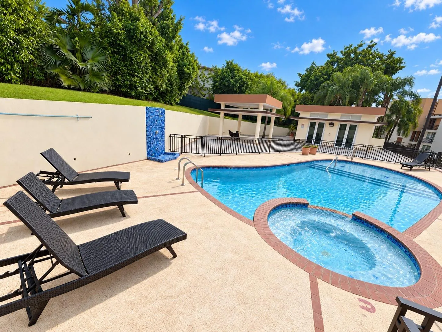 Community swimming pool and poolside lounge area.