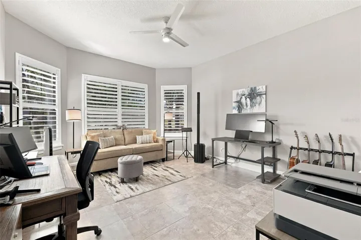 Large front Bedroom with bay window being used as an office and music room