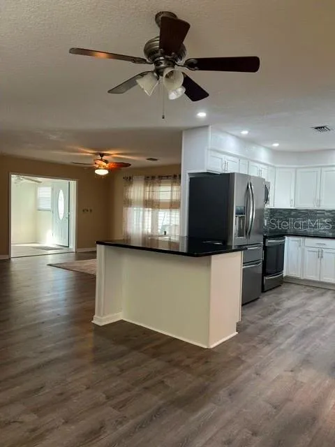Open concept with views of Kitchen, Living area, Florida Room and entryway.