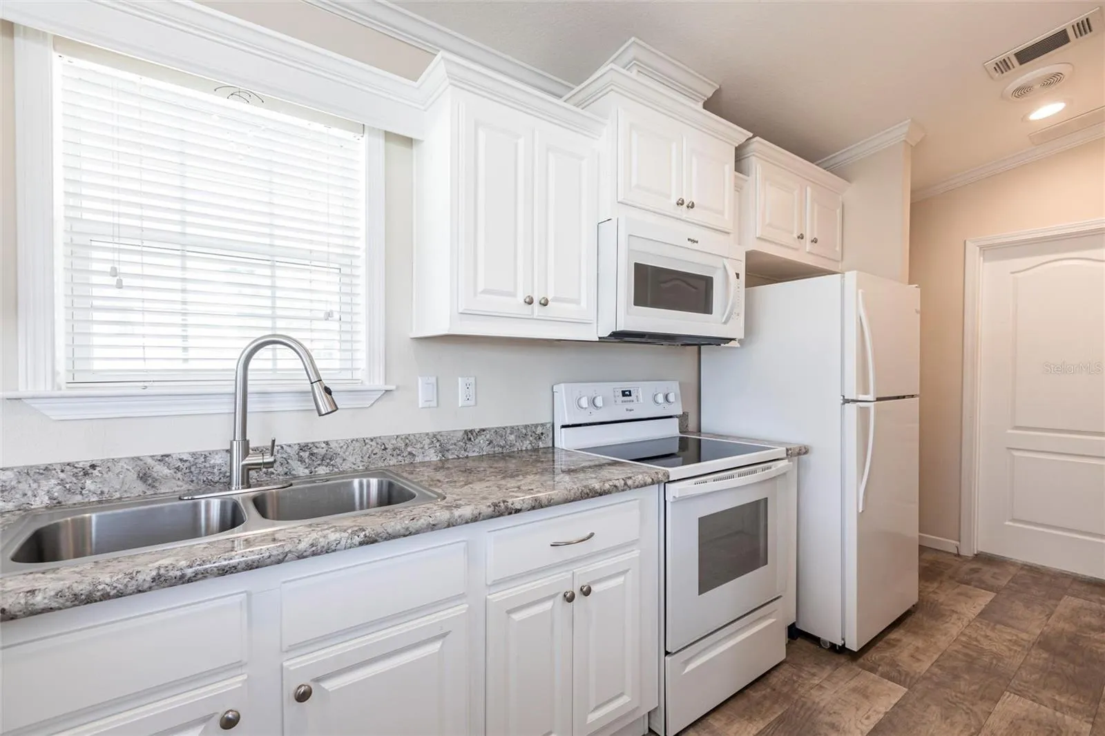 Kitchen with white cabinets and appliances