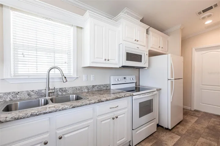 Kitchen with white cabinets and appliances