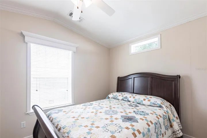 Bedroom with windows and ceiling fan