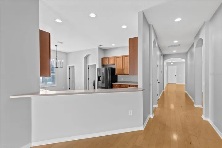 Hallway from front entry and flex room to kitchen