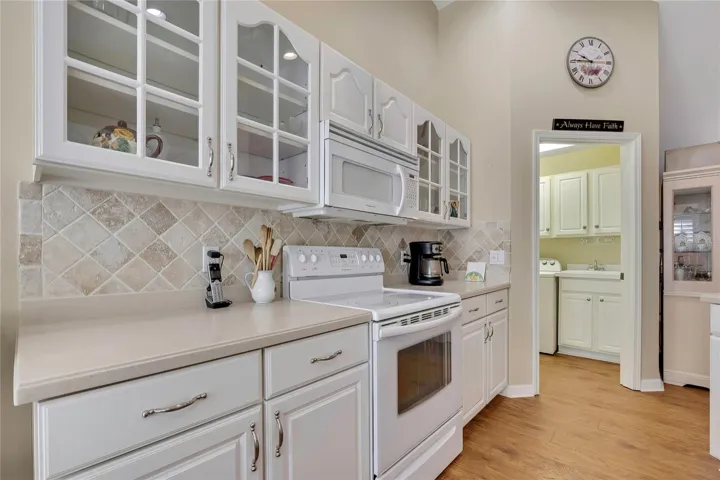 Kitcen with Wood and Glass Cabinets, Corian Counters