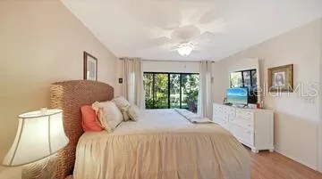 Primary Bedroom with Sliders to the Lanai overlooking the Lake
