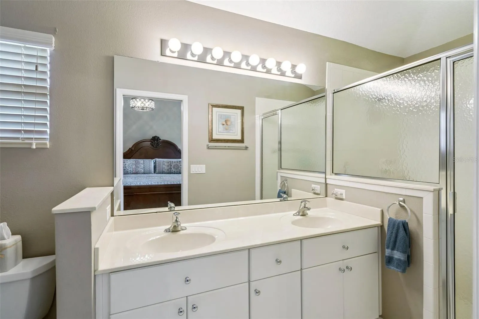 Primary bath with dual sinks and walk-in shower.