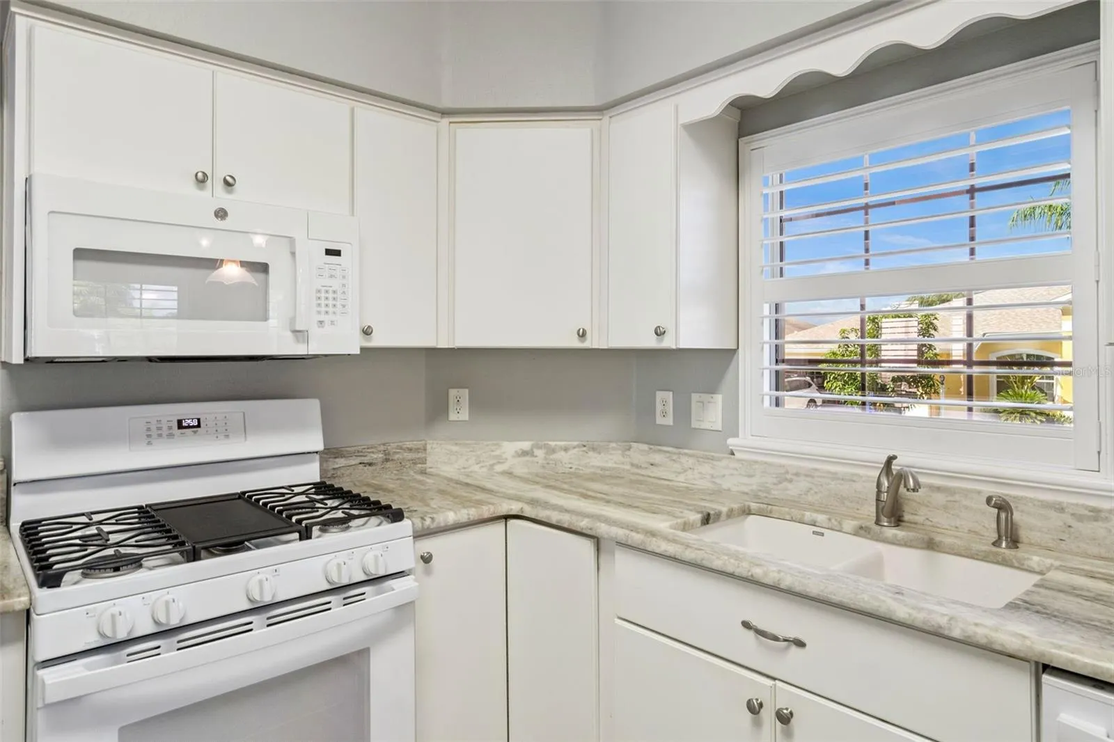Granite counters and a window over the sink.