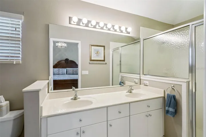 Primary bath with dual sinks and walk-in shower.