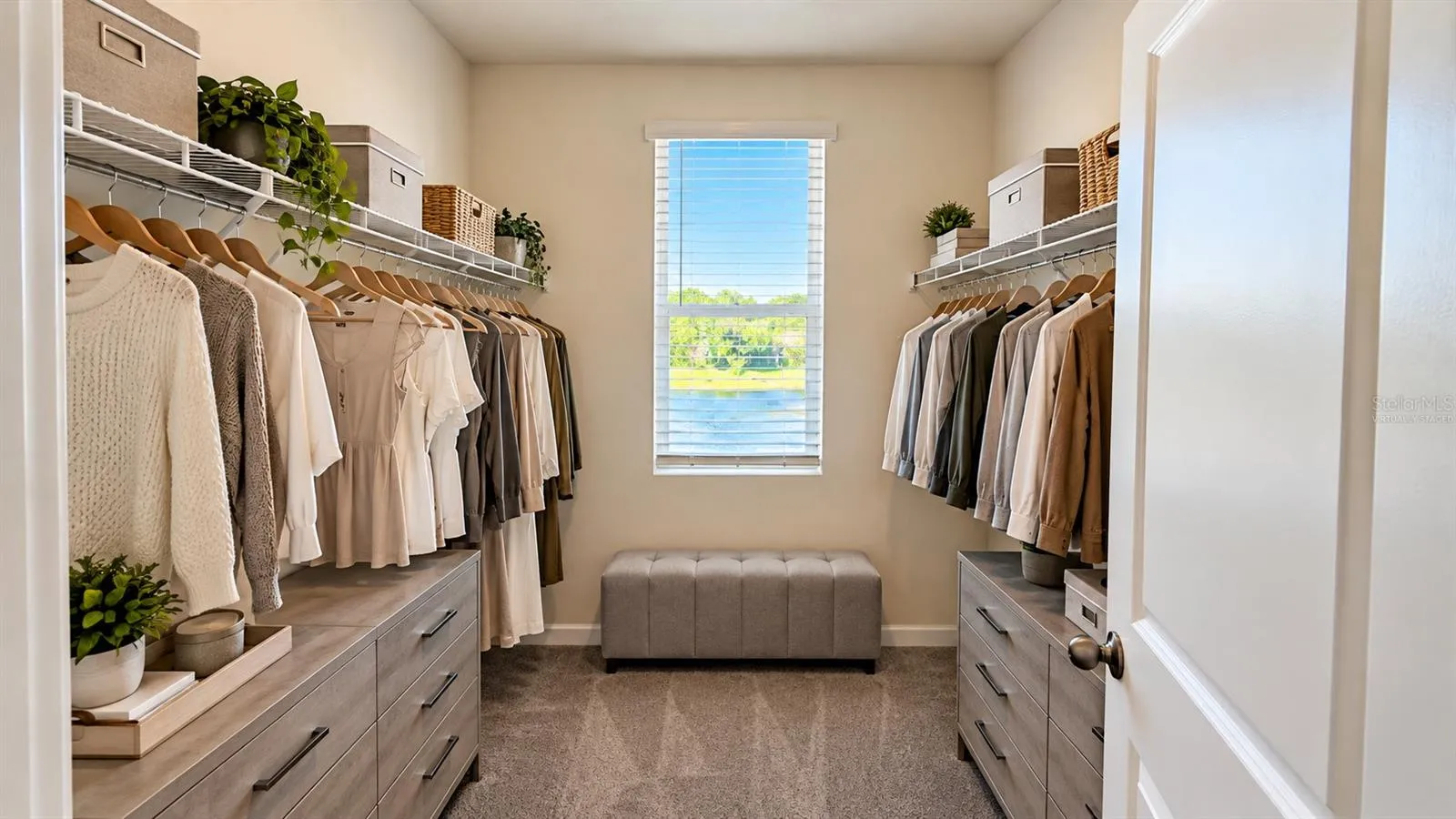 Walk-in closet - virtually staged clothing and decor.