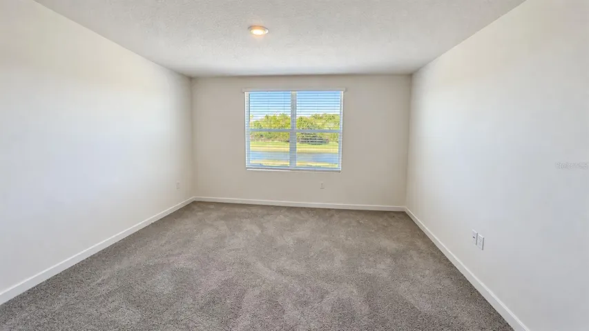 Primary bedroom - unfurnished; no virtual staging.