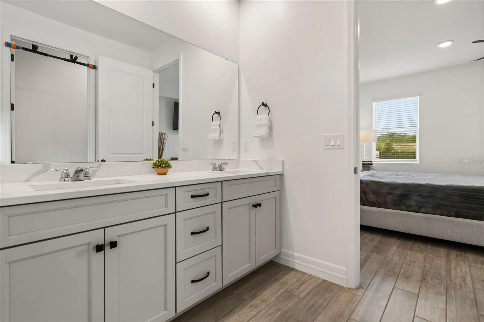 Primary bathroom at rear of home with view of greenbelt