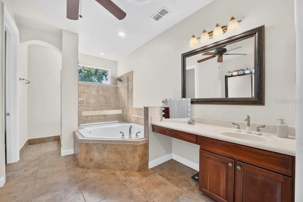 Primary ensuite with garden tub, separate walk-in shower and dual vanities