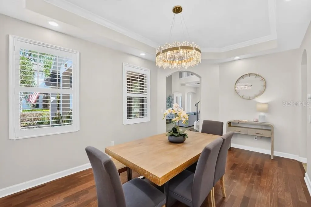Dining Room with double tray ceiling, crown molding and designer chandelier