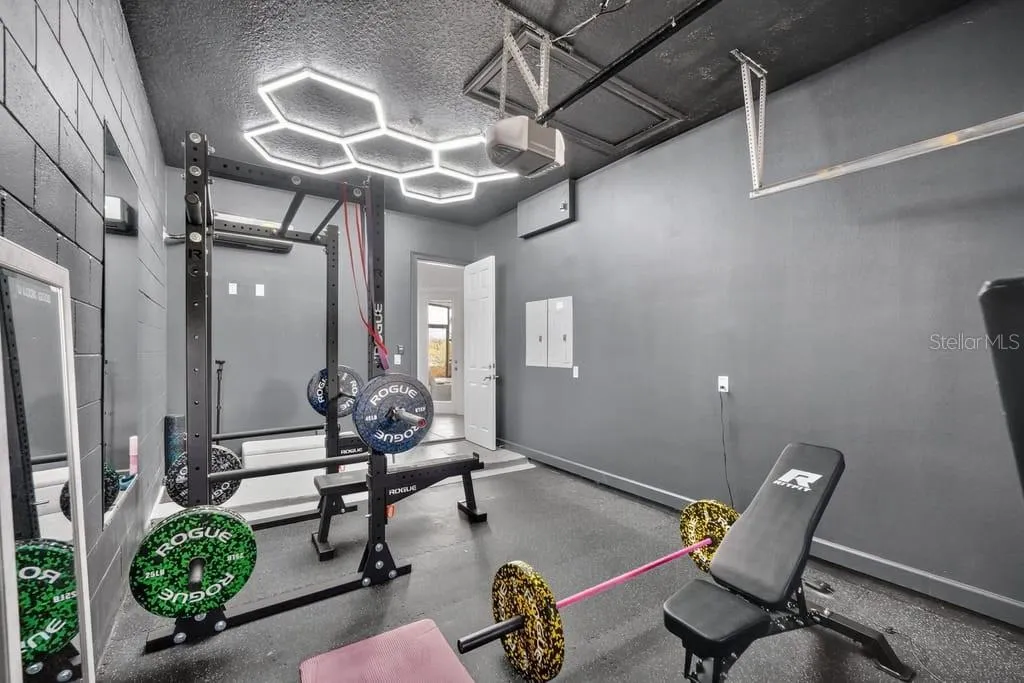 3rd Bay outfitted as a home gym with rubberized flooring, LED lighting and a ductless, mini-split AC unit
