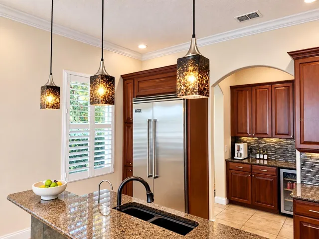 Cherry cabinetry, granite counters, decorative lighting, and top of the line appliances