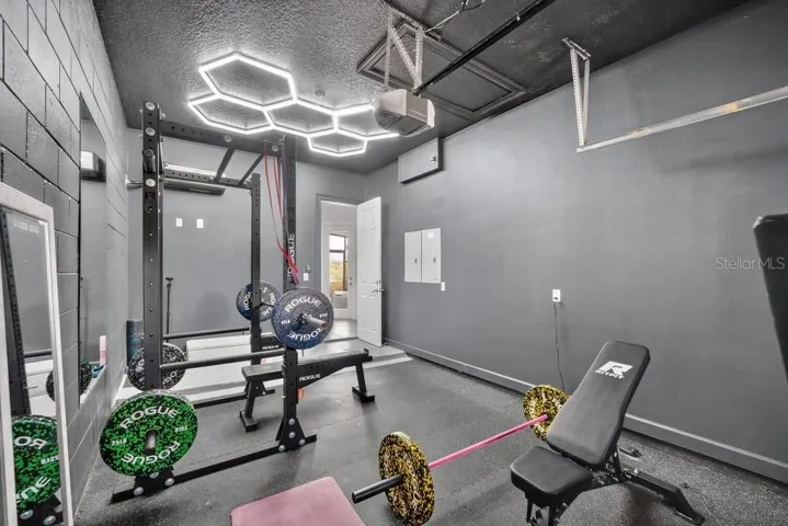 3rd Bay outfitted as a home gym with rubberized flooring, LED lighting and a ductless, mini-split AC unit