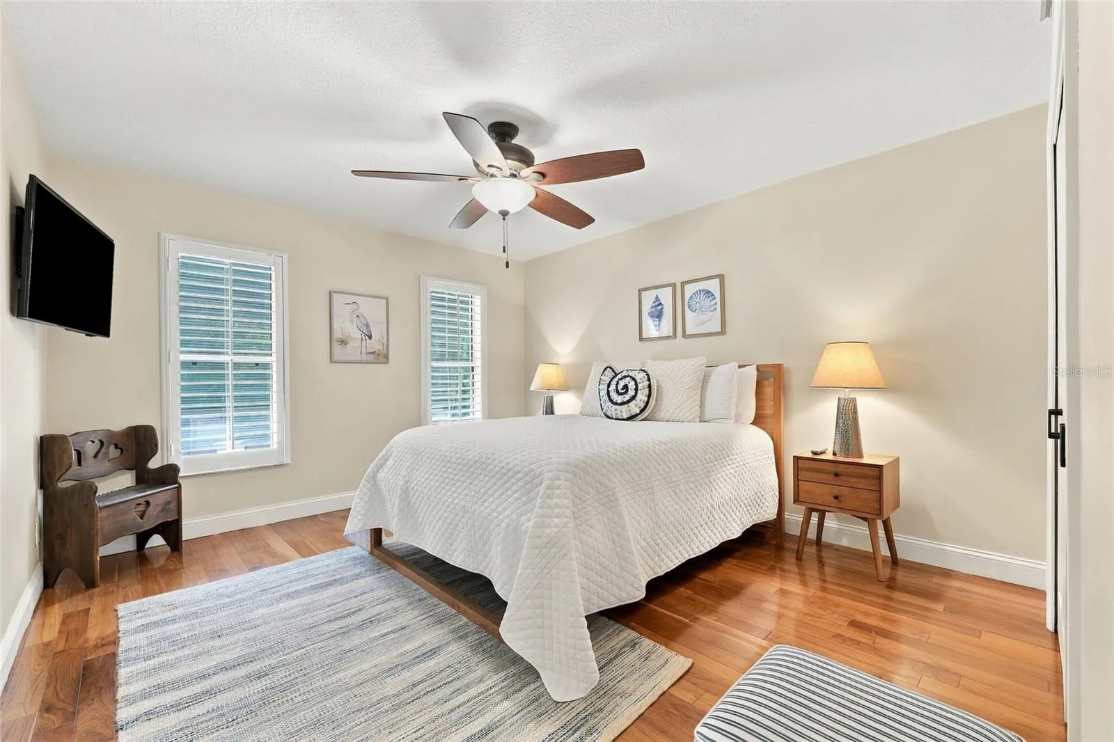 2nd guest bedroom with teak engineered floors &amp; plantation shutters