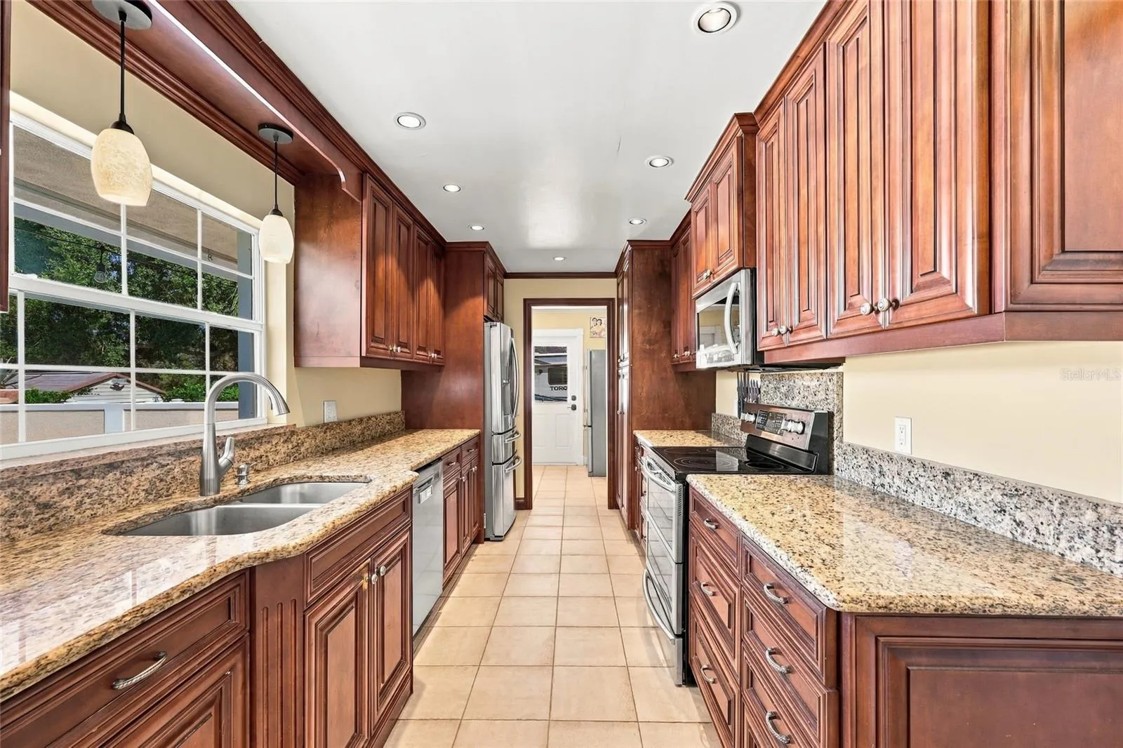 Kitchen with granite counters &amp; view of pool