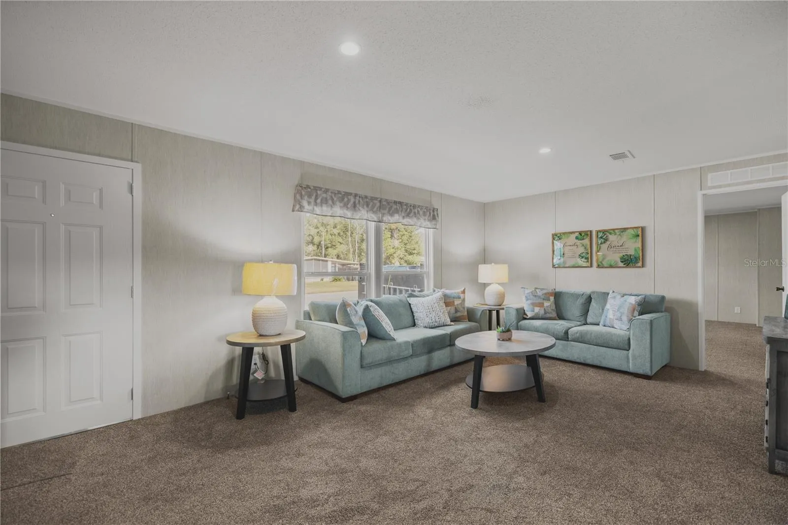 Enter into the bright living room with vaulted ceilings