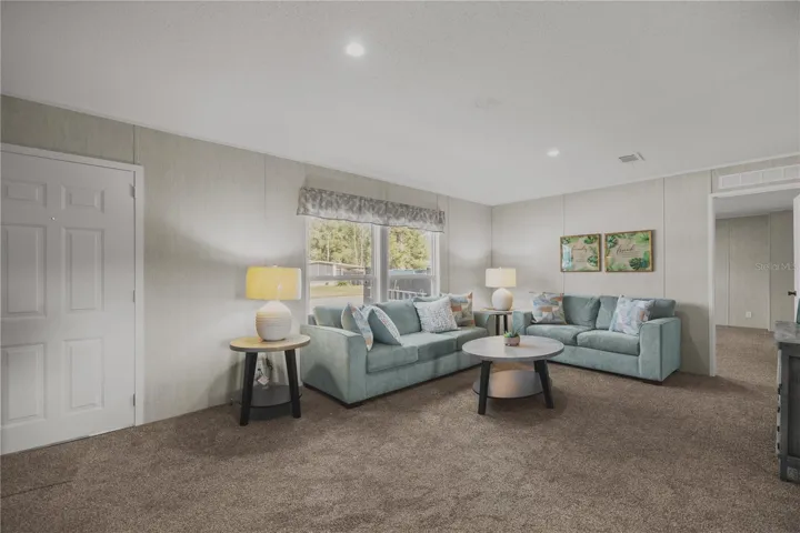 Enter into the bright living room with vaulted ceilings