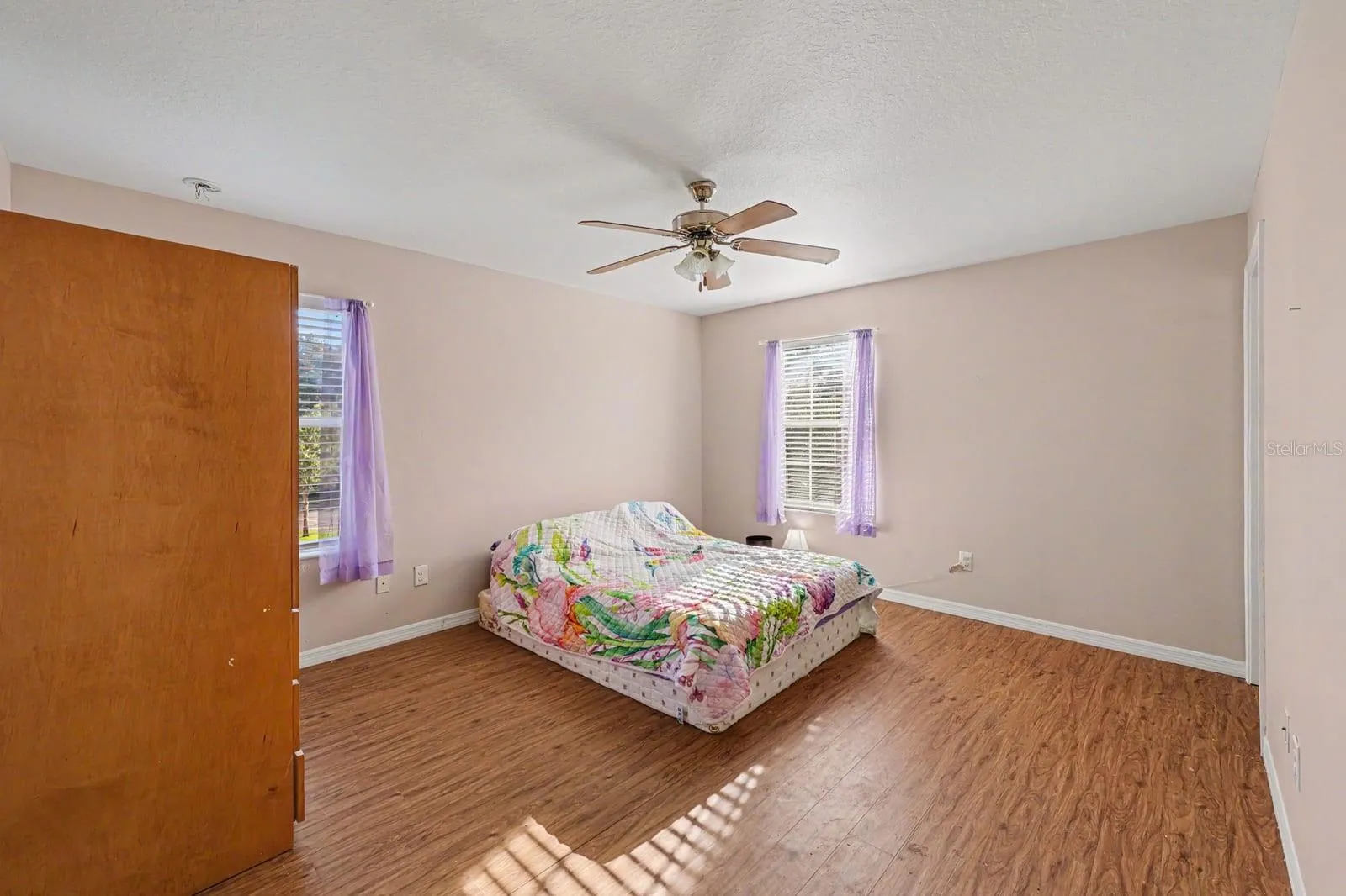 Large Bedroom with Multiple Windows, Wood Floors &amp; Ceiling Fan
