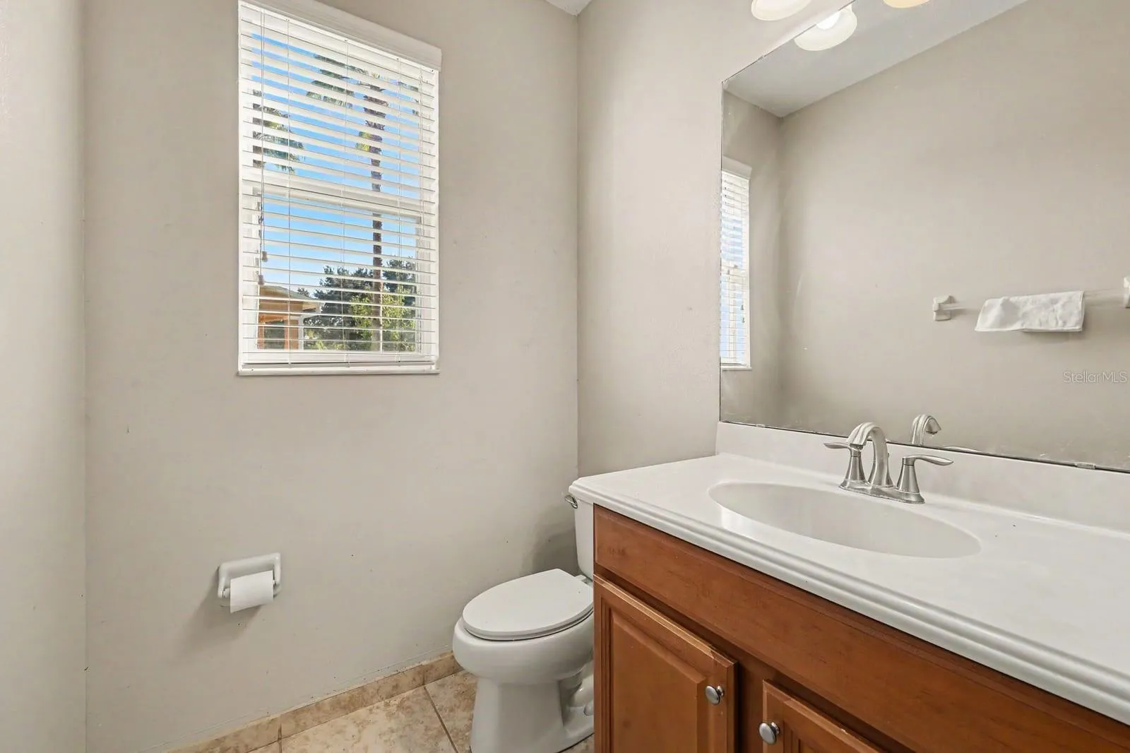 Master Bath Features Wood Vanity, Granite Countertop &amp; Window Light