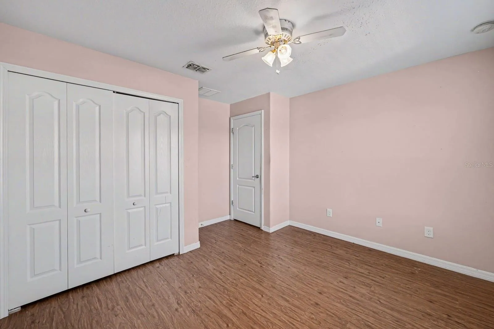 Master Bedroom with Multiple Closets, Windows &amp; Wood Flooring