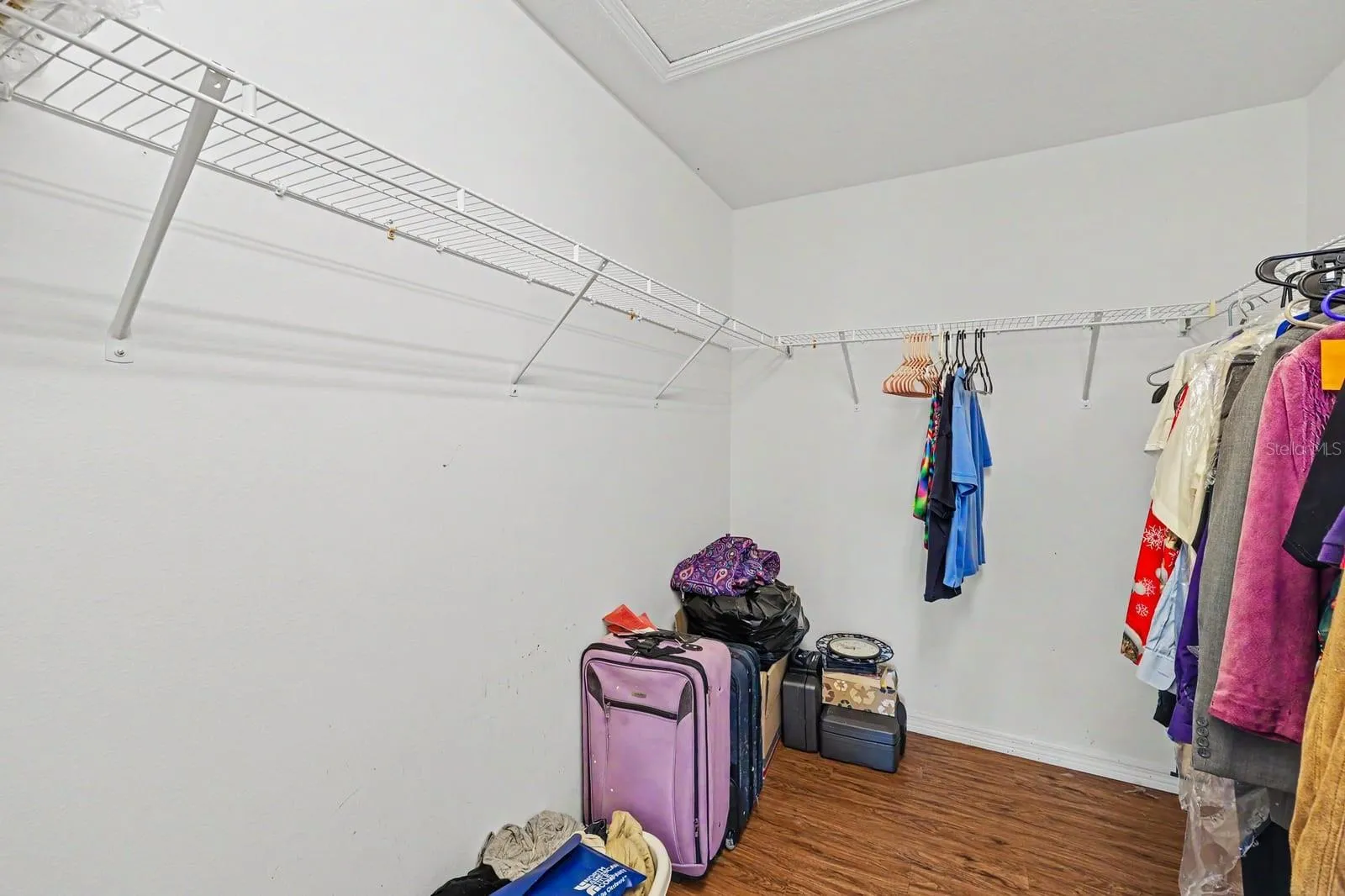 Organized Walk-In Closet with Shelving and Ample Storage Space