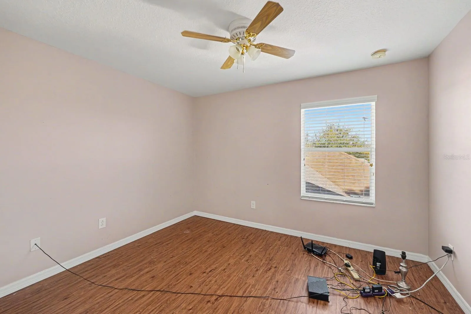 Secondary Bedroom With Pink Walls, Wood Floors &amp; Ceiling Fan