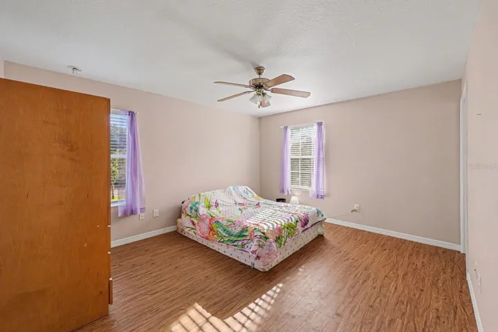 Large Bedroom with Multiple Windows, Wood Floors &amp; Ceiling Fan
