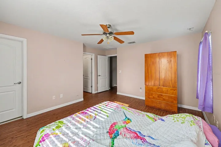 Master Suite with Walk-In Closets, Multiple Doors &amp; Wood Flooring