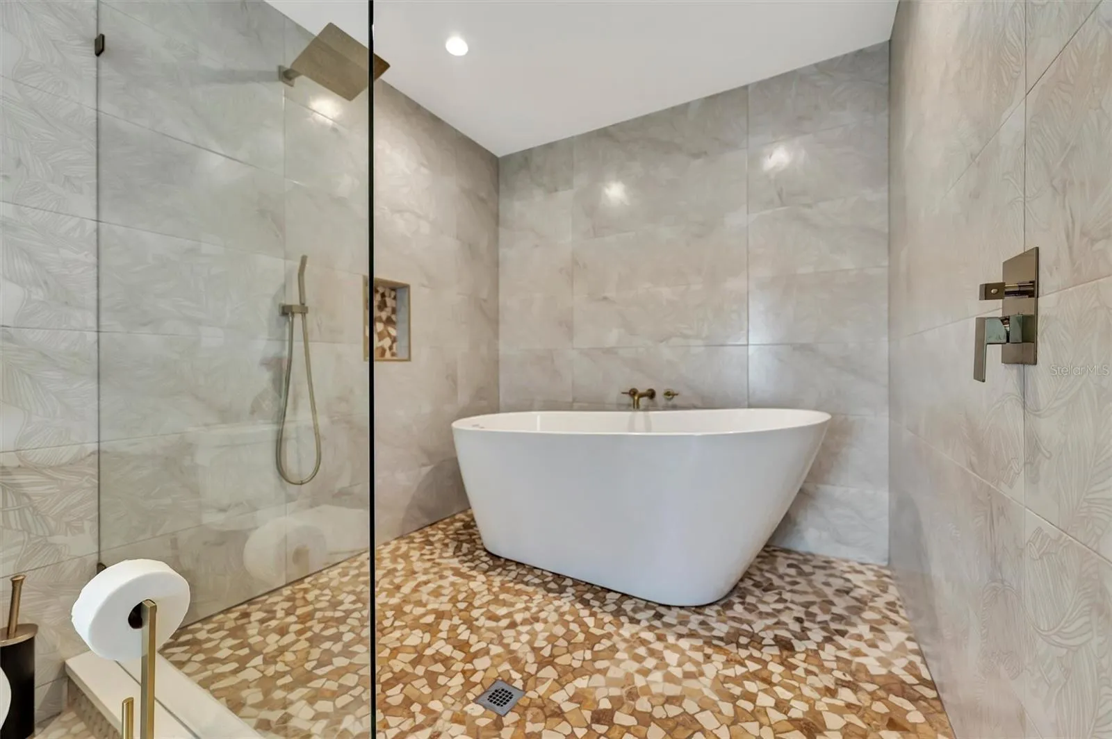 Updated bathroom with freestanding tub and separate shower.