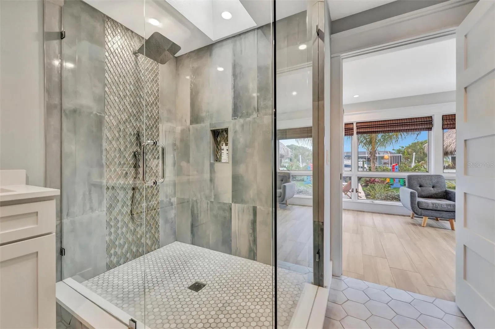 Spacious primary ensuite with double vanity and walk-in rain shower.
