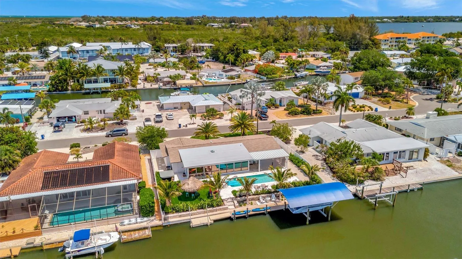 Approximately 90 feet of waterfront, updated seawall, composite dock, floating kayak/paddleboard dock, and covered 10,000-lb remote boat lift.