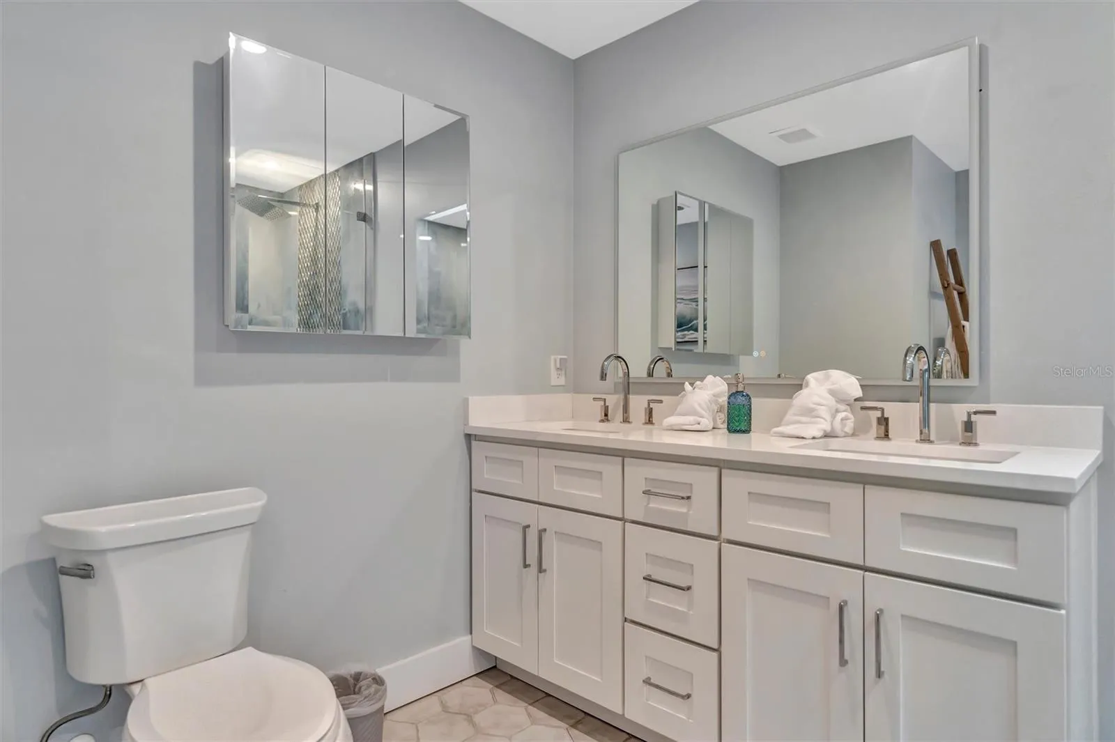 Spacious primary ensuite with double vanity and walk-in rain shower.