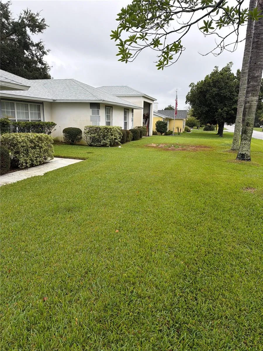 Charming Single-Story Home with Manicured Landscaping and Spacious Lawn