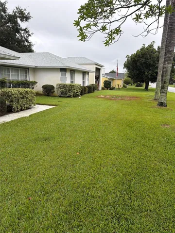 Charming Single-Story Home with Manicured Landscaping and Spacious Lawn