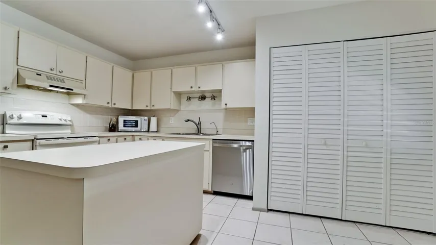 Full size washer & dryer behind the bifold doors