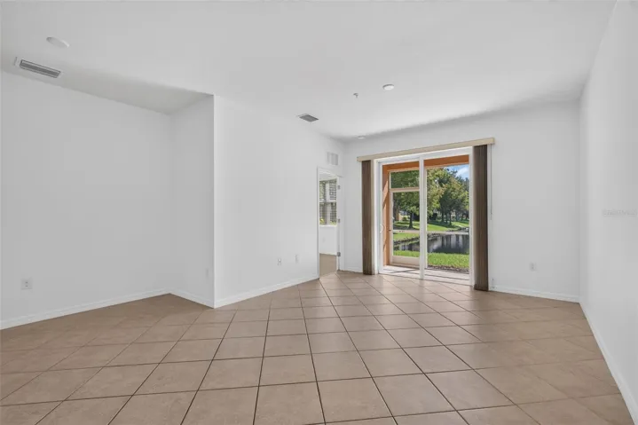 Dining and living room, sliders to the lanai and door to master bedroom