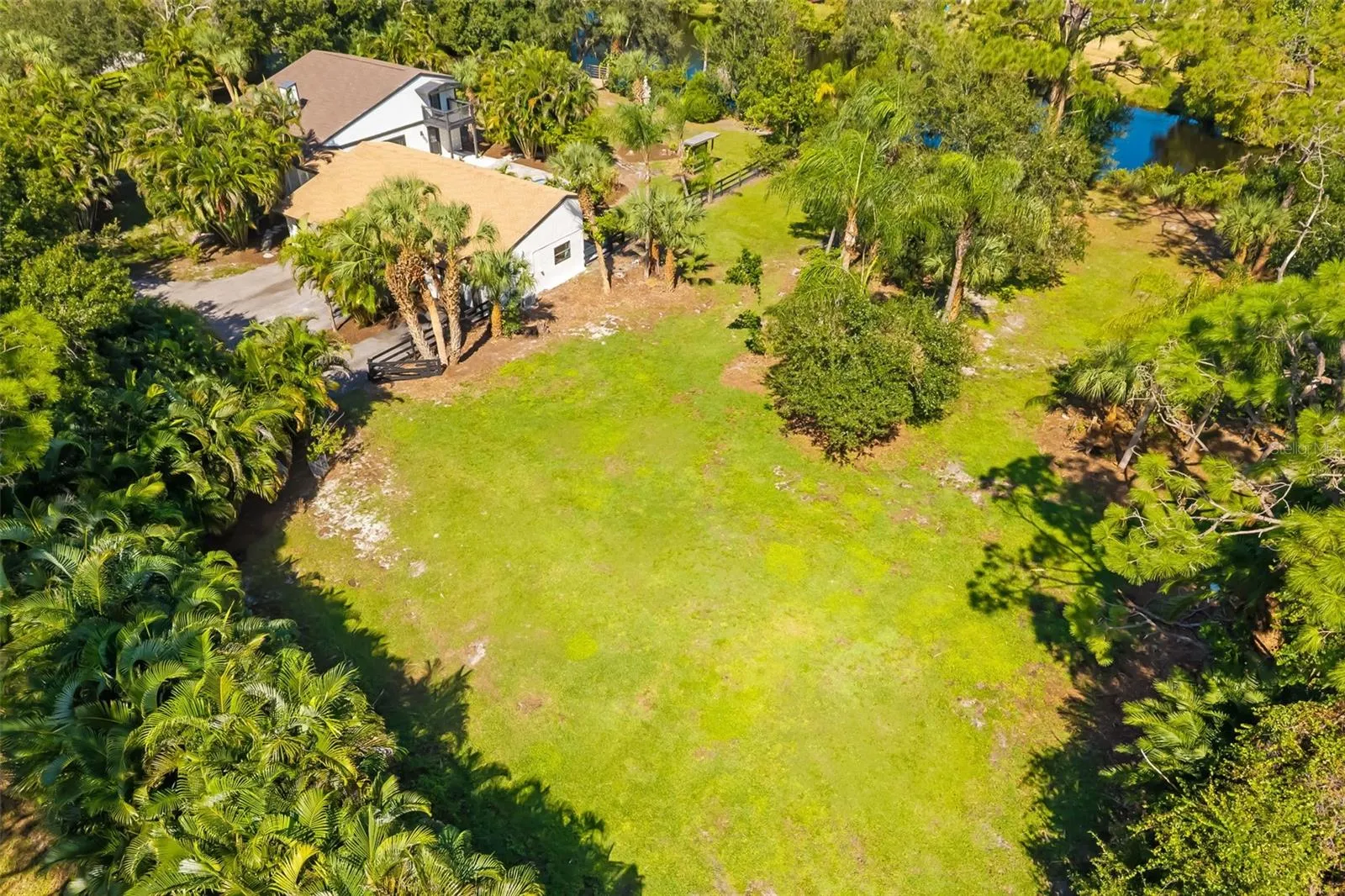 Aerial view highlighting the generous open area of this two-acre property—an exceptional opportunity to explore additional garage, workshop, recreational or equestrian uses, subject to applicable approvals.