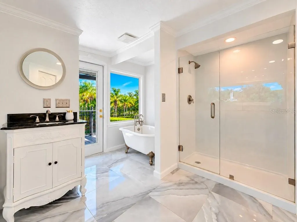 VIRTUALLY RENOVATED – Imagine the possibilities! Conceptual renovation of the upstairs primary bath featuring a freestanding tub, picture window and refreshed finishes. Improvements shown are not currently existing.