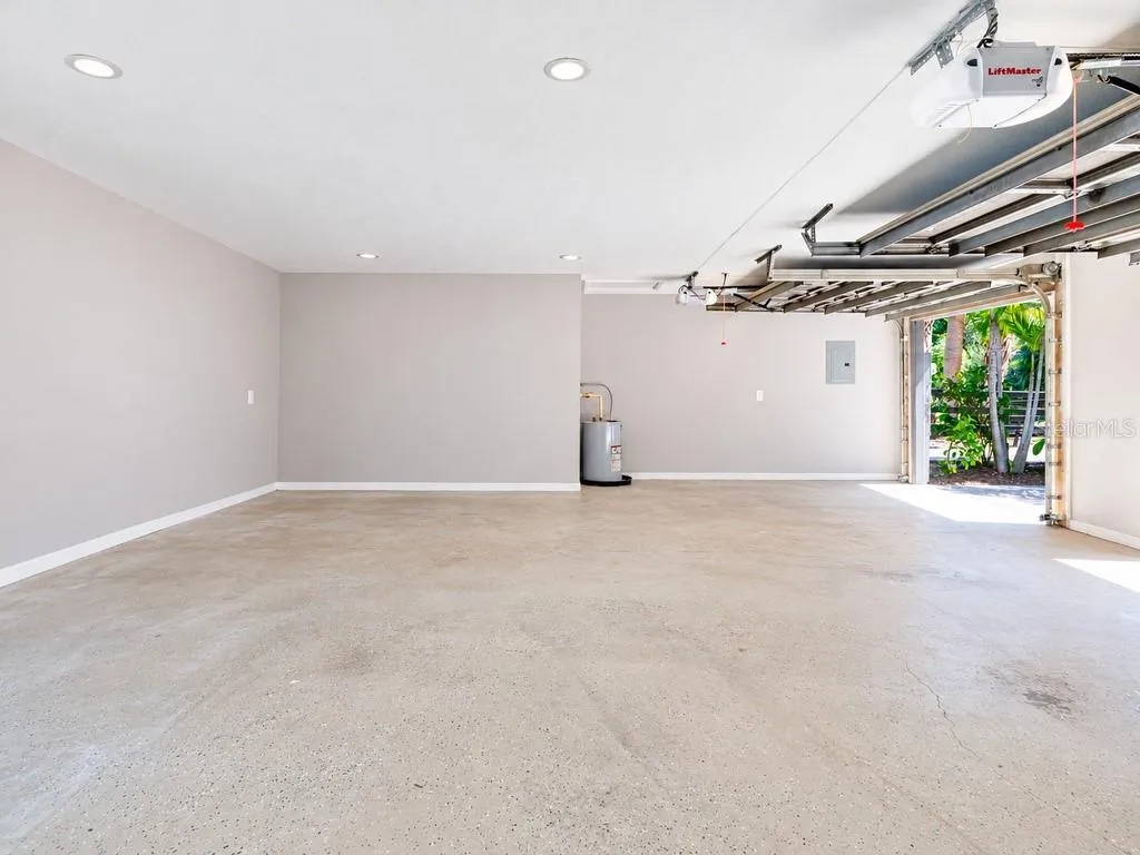 Another view of the extended three-car garage, showcasing the impressive open floor area and additional space for storage, a workshop or car enthusiast needs.