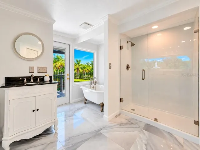 VIRTUALLY RENOVATED – Imagine the possibilities! Conceptual renovation of the upstairs primary bath featuring a freestanding tub, picture window and refreshed finishes. Improvements shown are not currently existing.