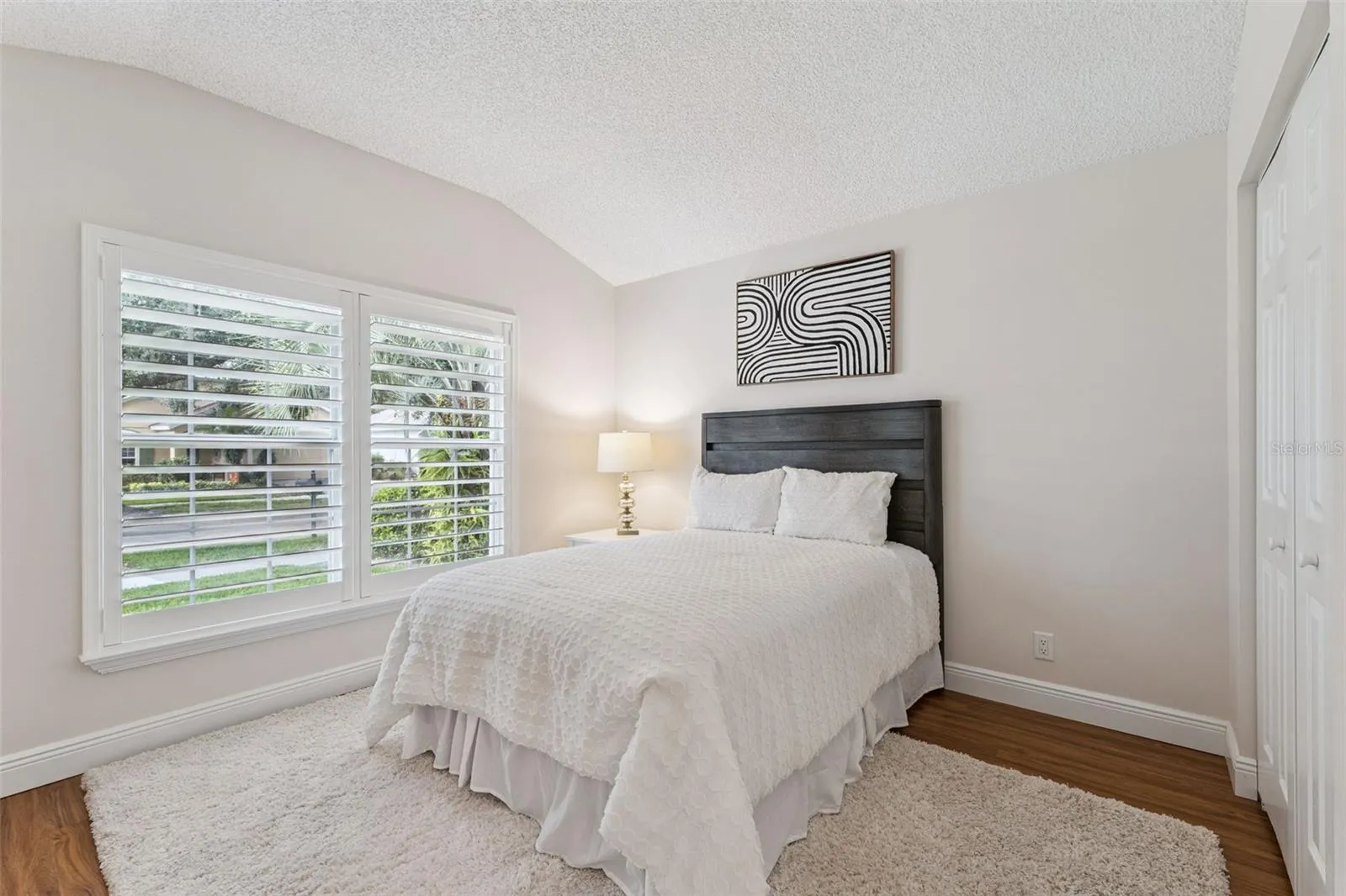 12' x 10'6" Bedroom #2 w/ laminate floor &amp; Plantation style shutters